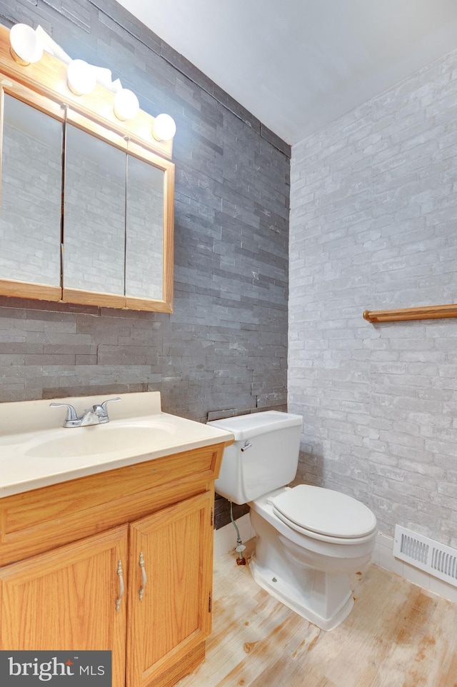 bathroom with vanity, wood-type flooring, and toilet