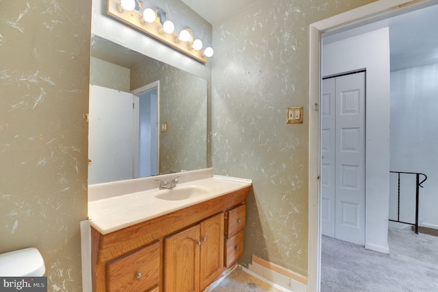 bathroom featuring vanity and toilet