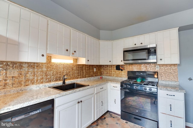 kitchen with light stone countertops, tasteful backsplash, sink, black appliances, and white cabinets