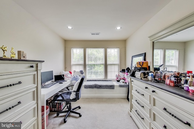 carpeted home office with plenty of natural light