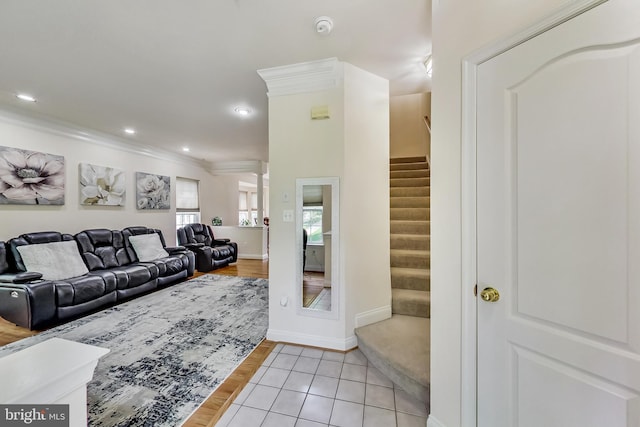 living room featuring light tile patterned floors and ornamental molding