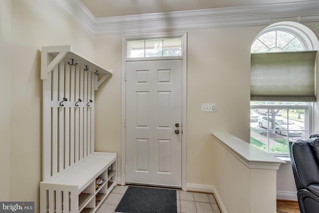 mudroom with light tile patterned floors and ornamental molding