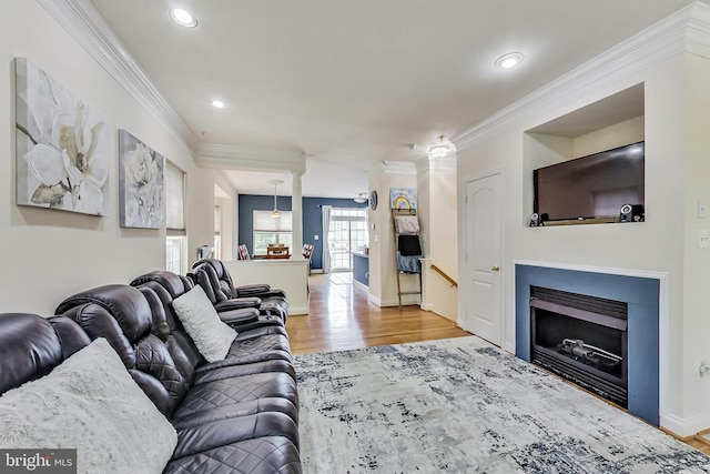 living room with ornamental molding and light wood-type flooring