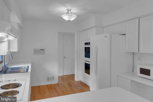 kitchen featuring light hardwood / wood-style flooring, sink, white appliances, and white cabinetry