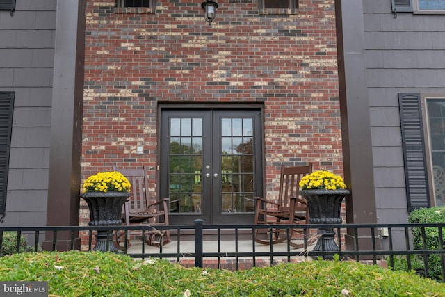 view of exterior entry featuring french doors