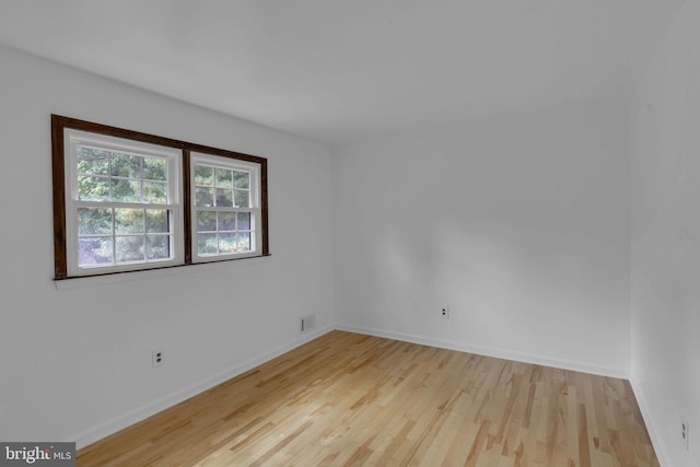 spare room with light hardwood / wood-style flooring