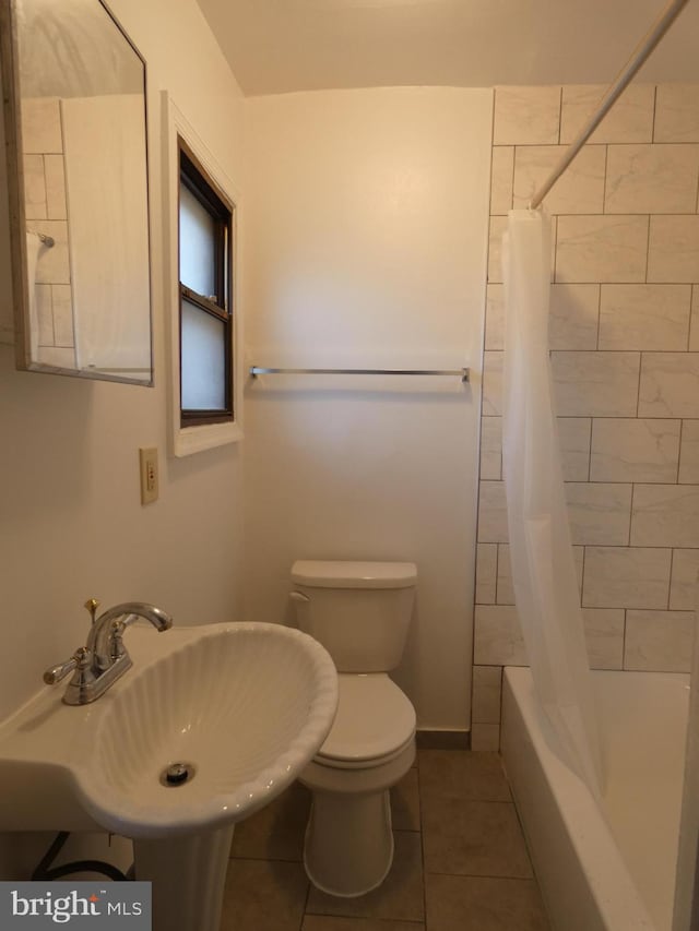 full bathroom with sink, shower / tub combo, toilet, and tile patterned flooring