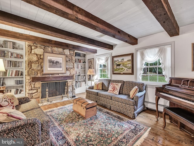 1414 Little Ln, Seven Valleys, PA 17360 - living room with hardwood / wood-style flooring, a baseboard radiator, a stone fireplace, and a healthy amount of sunlight