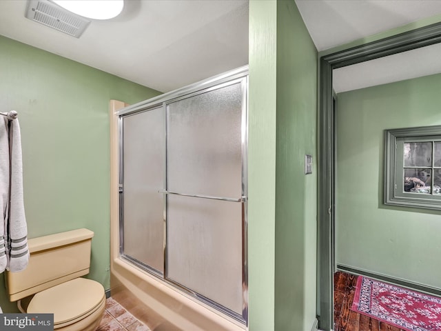 1414 Little Ln, Seven Valleys, PA 17360 - bathroom featuring toilet, wood finished floors, visible vents, and bath / shower combo with glass door
