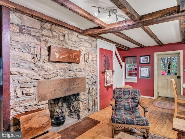 1414 Little Ln, Seven Valleys, PA 17360 - living area with wood finished floors, beamed ceiling, and a fireplace
