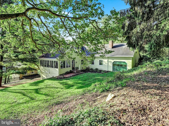 1414 Little Ln, Seven Valleys, PA 17360 - exterior space featuring a sunroom, a yard, roof with shingles, fence, and a chimney