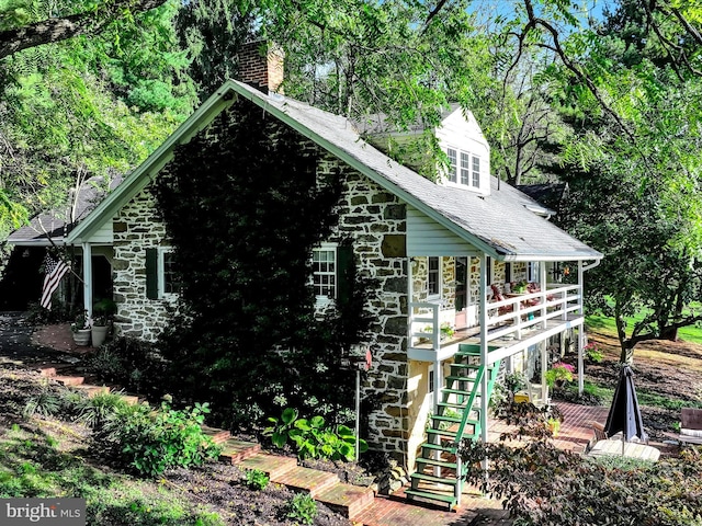 1414 Little Ln, Seven Valleys, PA 17360 - view of property exterior featuring stairs, stone siding, a chimney, and a shingled roof