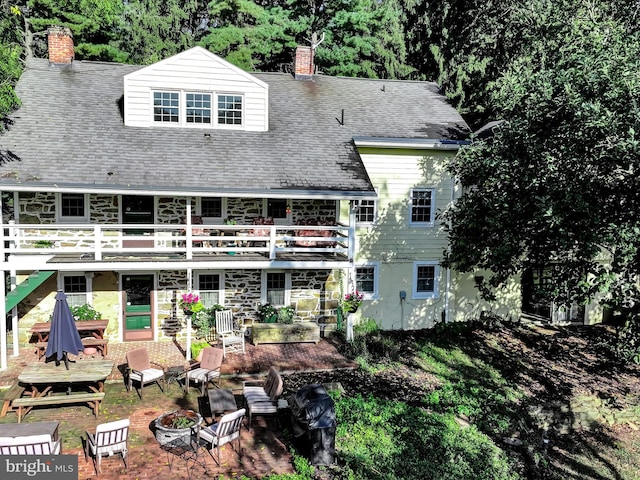 1414 Little Ln, Seven Valleys, PA 17360 - rear view of house with a shingled roof, a chimney, a patio area, and a fire pit