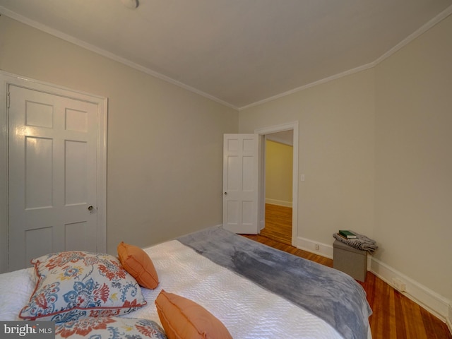 bedroom featuring hardwood / wood-style floors and crown molding