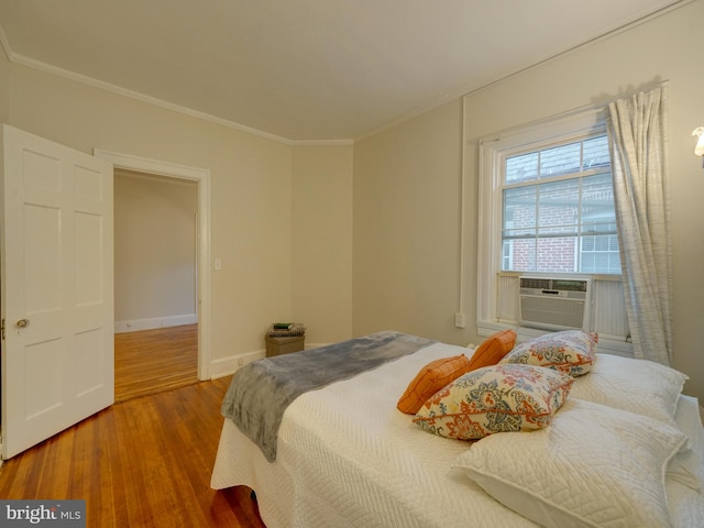 bedroom featuring ornamental molding and hardwood / wood-style floors