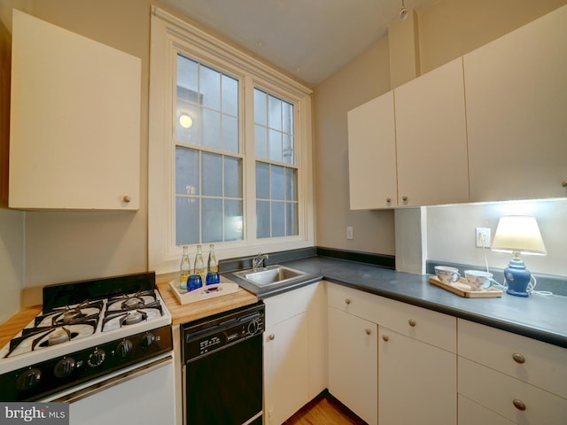 kitchen with dishwasher, light hardwood / wood-style floors, gas range gas stove, sink, and white cabinetry