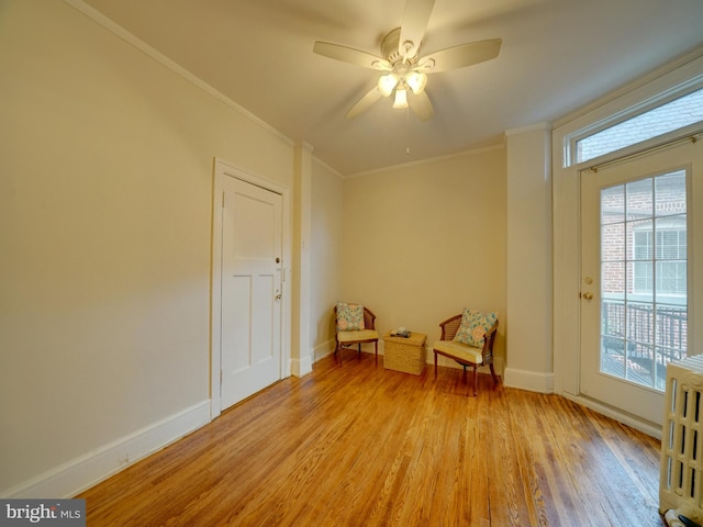 unfurnished room with light wood-type flooring, ornamental molding, and ceiling fan