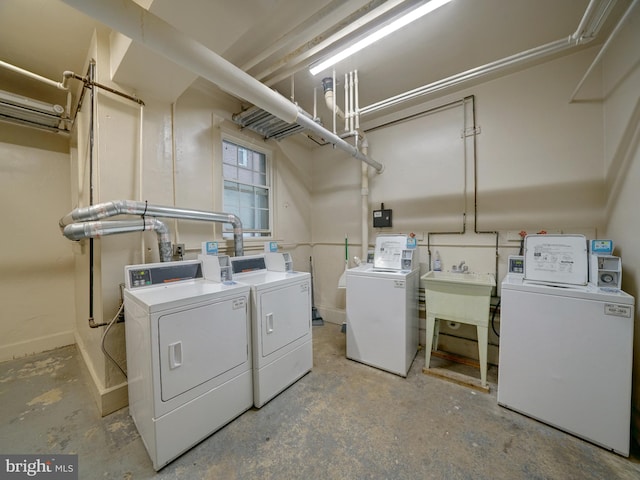 laundry area featuring washer and clothes dryer and sink