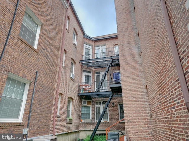 view of side of home with a balcony and central AC