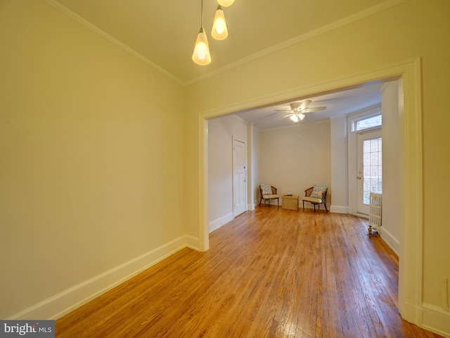 spare room featuring ornamental molding, hardwood / wood-style floors, and ceiling fan