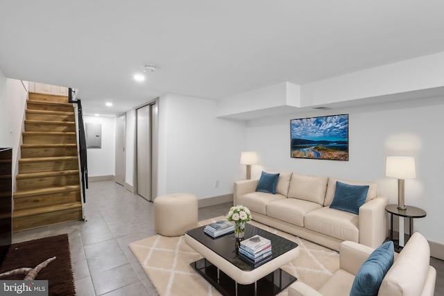 living room featuring electric panel and light tile patterned floors