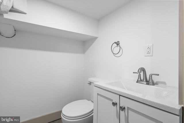 bathroom with toilet and vanity