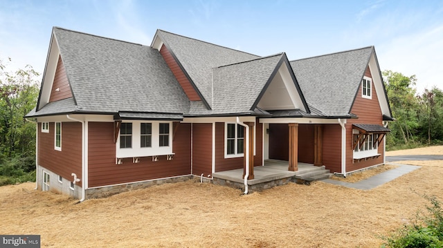 rear view of property with a porch