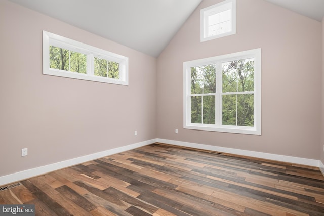 unfurnished room featuring lofted ceiling and dark hardwood / wood-style floors