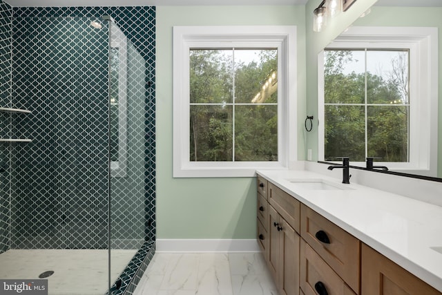 bathroom featuring a tile shower and vanity