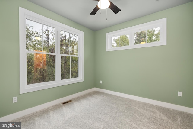 carpeted empty room featuring ceiling fan