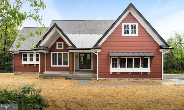 rear view of house featuring covered porch