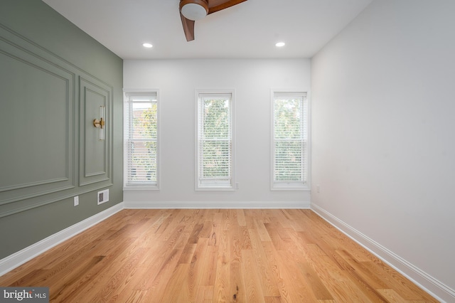 empty room featuring light hardwood / wood-style flooring and ceiling fan