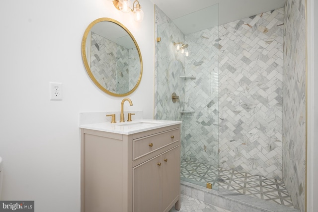 bathroom with vanity and tiled shower