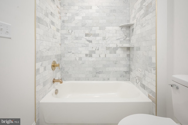 bathroom with tiled shower / bath combo and toilet