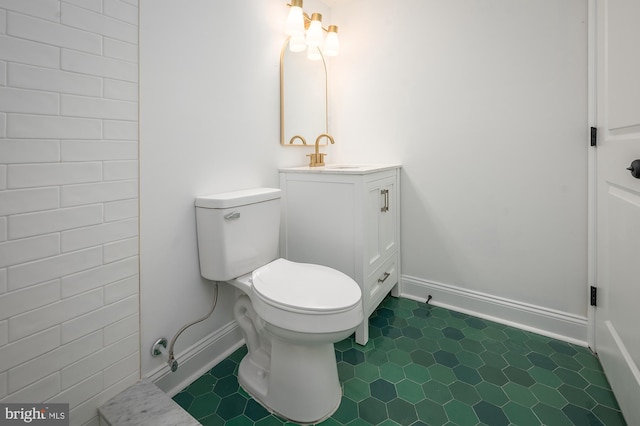 bathroom with vanity, toilet, and tile patterned floors