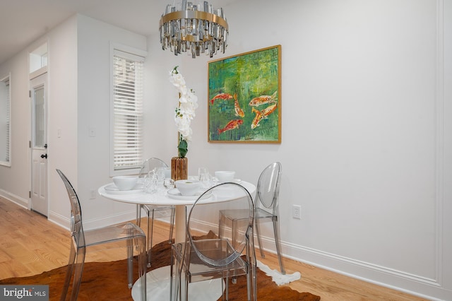 dining room with a chandelier and hardwood / wood-style flooring