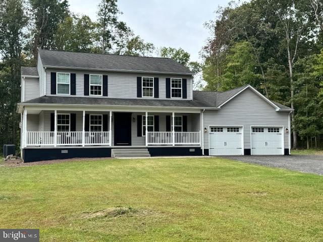 view of front of property with a porch, a front lawn, central AC, and a garage