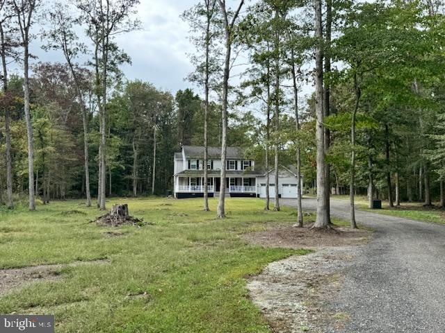 view of front of home with a garage and a front lawn