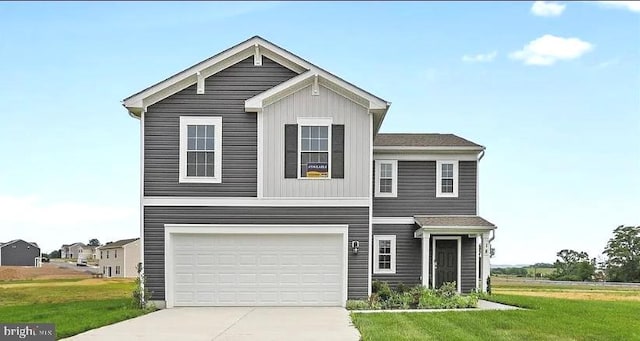 view of front of home with a front lawn and a garage