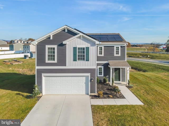 18 Smokehouse Rd, Carlisle, PA 17013 - traditional-style house with roof mounted solar panels, board and batten siding, a garage, concrete driveway, and a front yard