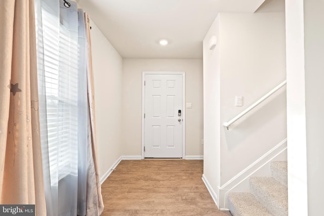 doorway with light wood-type flooring