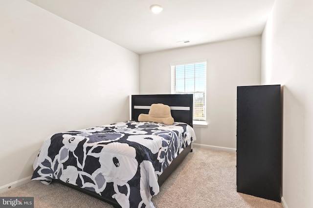 bedroom with light colored carpet