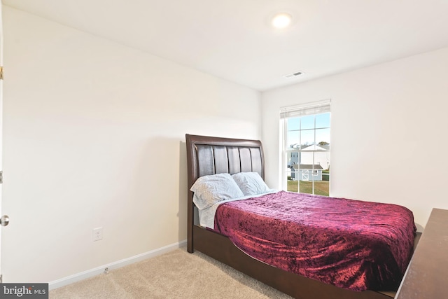 bedroom with light colored carpet