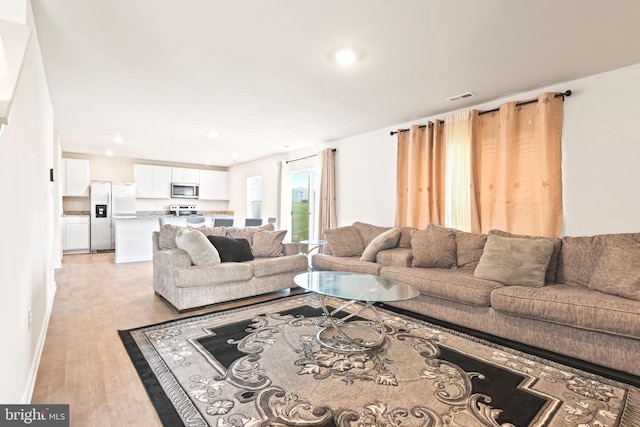 living room with light hardwood / wood-style flooring