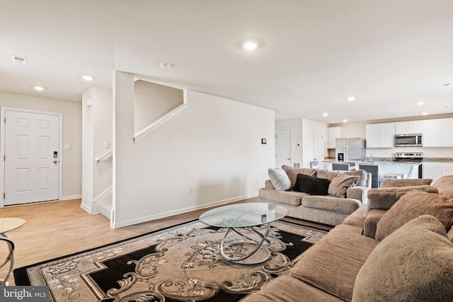 18 Smokehouse Rd, Carlisle, PA 17013 - living room featuring baseboards, light wood-type flooring, recessed lighting, and stairway