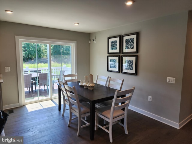 dining space with dark wood-type flooring