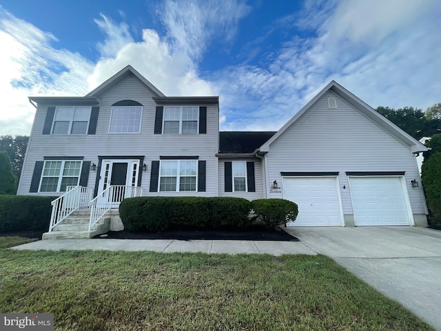 view of front of house with a front lawn and a garage