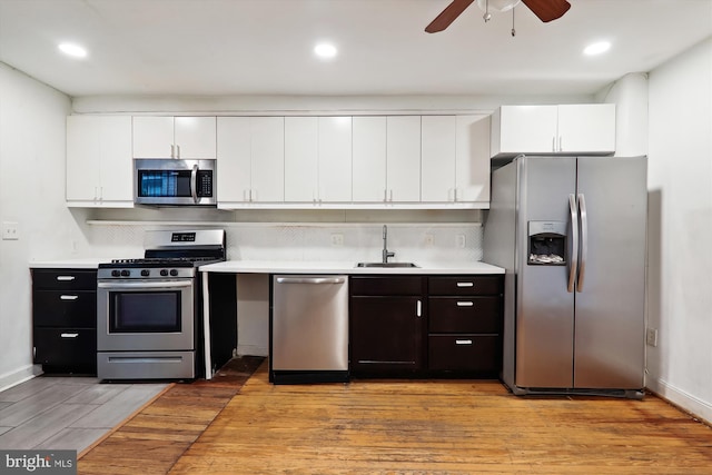 kitchen featuring ceiling fan, sink, light hardwood / wood-style flooring, white cabinetry, and appliances with stainless steel finishes