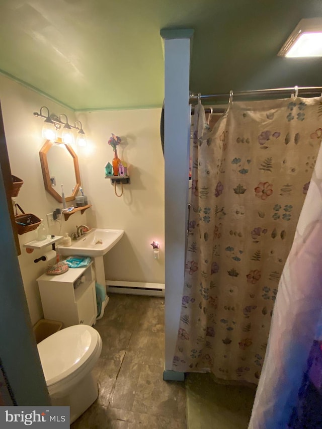 bathroom with curtained shower, sink, baseboard heating, wood-type flooring, and toilet