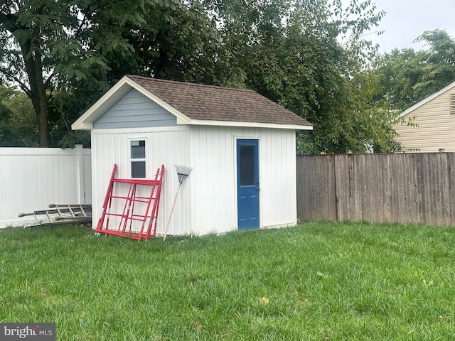 view of outbuilding featuring a yard